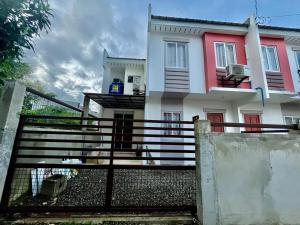 a house with a staircase in front of it at Loven Transient House in Dauis