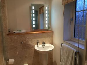 a bathroom with a sink and a mirror at SleepNeat in Ascot +30 photos