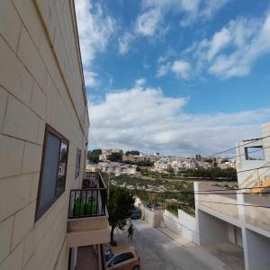 a view of a city from a balcony of a building at Luxury 9 person Holiday Home a walk to Paceville's nightlife in Is-Swieqi