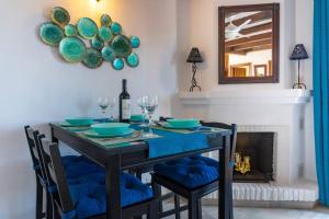 a dining room with a blue table and chairs at Idyllic Townhouse with Scenic Views Mijas Pueblo in Mijas