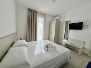 En eller flere senge i et værelse på ADAGIO by Verde Blu Vacanze