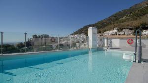 a large swimming pool with a view of a city at Stylish Central Apartment & Panoramic Views Mijas in Mijas