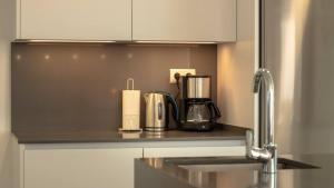 a kitchen counter with a coffee maker on it at Stylish Central Apartment & Panoramic Views Mijas in Mijas