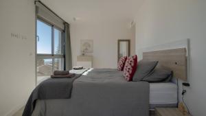 a bedroom with a large bed and a large window at Stylish Central Apartment & Panoramic Views Mijas in Mijas +21 photos