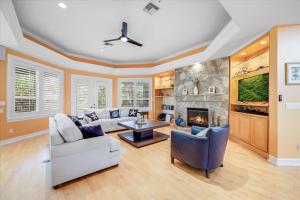 a living room with a couch and a fireplace at Coconut Palm House in Captiva