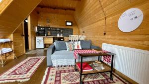 a living room with a couch and a table at AURA Cottages in Kazbegi