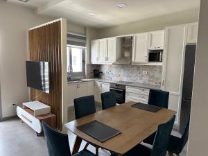 a kitchen with a wooden table and a dining room at Voudouris house in Ampavris