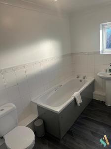 a bathroom with a tub and a toilet and a sink at Overton View in Stockton-on-Tees