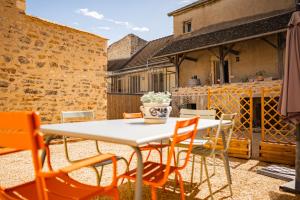 a white table and chairs on a patio at Gîte des Cadoles in Saint-Jean-de-Vaux