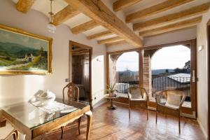a dining room with a table and a large window at La Creu De La Pinya in Berga