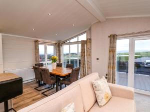 a living room with a couch and a table at Holly Lodge in Whitby