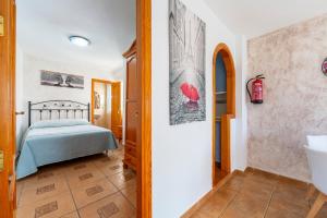 a bedroom with a bed and a bathroom at Maracas 2 in El Pozo de los Frailes