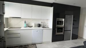 a kitchen with white cabinets and a refrigerator at Wohnung in Hanau in Hanau am Main +9 photos