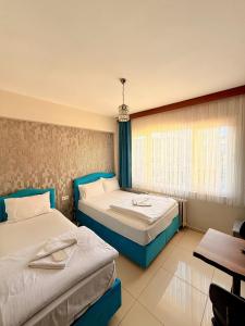 a hotel room with two beds and a table at HİSAR HOTEL in Istanbul