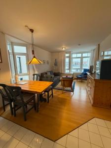 a living room with a wooden table and a dining room at Ferienwohnungen Alte Schmiede 9 in Norderney