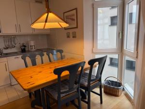 a wooden table in a kitchen with chairs around it at Ferienwohnungen Alte Schmiede 9 in Norderney