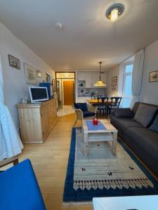 a living room with a couch and a table at Ferienwohnungen Alte Schmiede 9 in Norderney