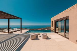 a villa with a swimming pool and a view at Thea Marre in Neokhórion +28 photos