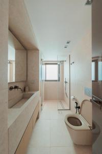 a bathroom with a toilet and a sink and a shower at Thea Marre in Neokhórion