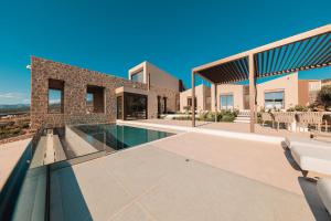 a villa with a swimming pool and a house at Thea Marre in Neokhórion
