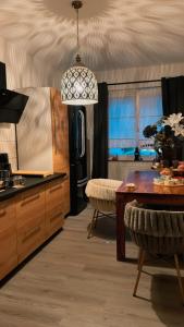 a kitchen with a table and a dining room at Luxury Stay Düsseldorf Altstadt Moments in Düsseldorf