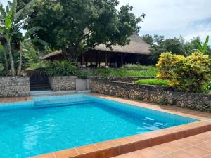 a swimming pool in front of a resort at Sumba Nautil Resort in Sumba +9 photos