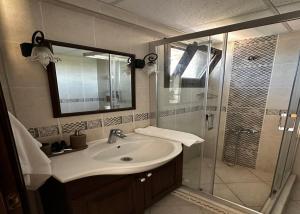 a bathroom with a sink and a shower at Nergis Hotel in Karaburun +108 photos
