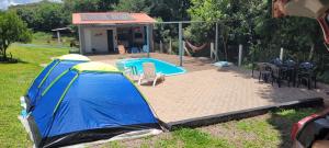 a blue tent is next to a swimming pool at Sitio marau rs in Marau