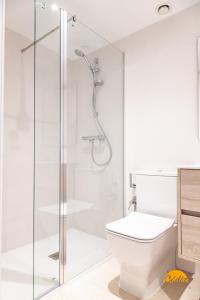 a white bathroom with a shower and a toilet at Villalobos by Cadiz Time in Cádiz +95 photos