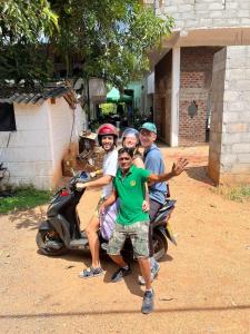 a group of people sitting on a scooter at Pick Me Village in Dambulla +1 photo
