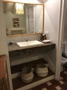 a bathroom with a sink and a mirror at Casa Lola in Yerba Buena +27 photos