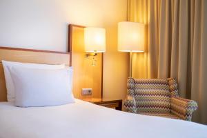 Postel nebo postele na pokoji v ubytování The Q - Quadro City Hotel