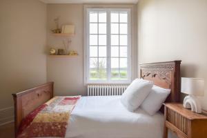 a bedroom with a bed with a large window at Le Domaine de Flancourt - Échappée Belle en tribu in Flancourt-Crescy-en-Roumois +50 photos
