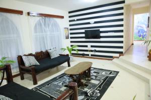 a living room with a black and white striped wall at Nyali Furnished Rooms With Swimming in Mombasa