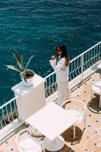 a woman talking on a cell phone on a cruise ship at Miramare Sea Resort & Spa in Ischia