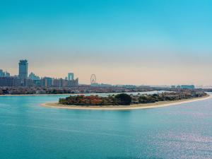 an island in the middle of a body of water at C Central Hotel and Resort The Palm in Dubai