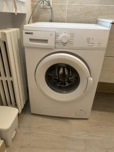 a washing machine in a bathroom with a toilet at Angelica apartment in Sirmione