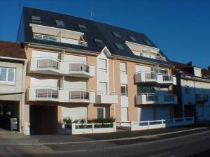 a large apartment building with balconies on a street at Appartement lumineux 2 chambres avec balcon, à 500m de la plage - Centre-ville Stella-Plage - FR-1-236-65 in Cucq
