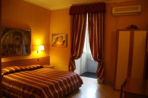 a hotel room with a bed and a window at Hotel Milazzo Roma in Rome +16 photos