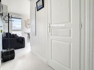 a white door with a sign on it in a room at Charmant T2 à Stella-plage, proche mer, tout confort - FR-1-236-147 in Cucq