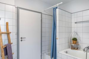 a bathroom with a shower and a tub and a sink at Ferienwohnung Altstadtblick in Alsfeld +22 photos