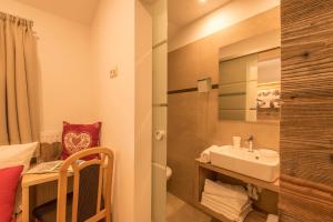 a small bathroom with a sink and a shower at Familyapartment Alpe - Unterkehrhof in Laion