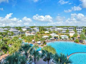 an aerial view of a resort with a pool and palm trees at Penthouse Paradise Condo at Seacrest in Rosemary Beach
