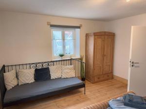 a living room with a couch and a window at Oberbayern Lengenfeld 2 Wohnungen a 4 Schlafzimmer Neu umgebaut in Pürgen +46 photos