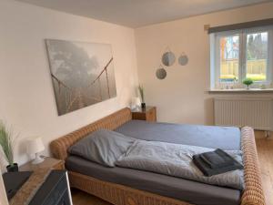 a bedroom with a bed with a wicker bed frame at Oberbayern Lengenfeld 2 Wohnungen a 4 Schlafzimmer Neu umgebaut in Pürgen