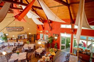 a restaurant with tables and chairs in a room at VTF Ker Belen in Riec-sur-Bélon +20 photos
