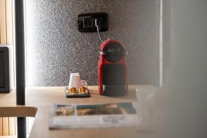 a table with a coffee maker and a magazine at Skia by Premium Key in Skiathos