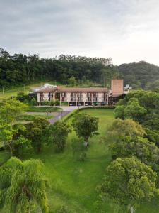 an aerial view of a building in the middle of trees at Bormon Hotel in Nova Veneza