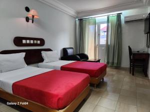 Postel nebo postele na pokoji v ubytování Golden Hôtel