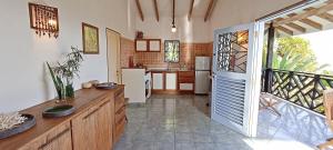 a large kitchen with a door open to a kitchen with at Amuse Bush Villa in Mahe